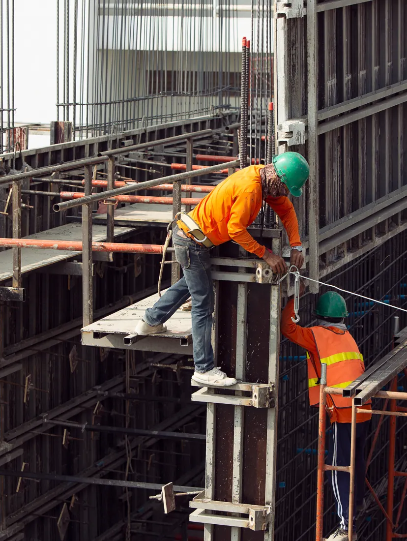Workers assembling formwork on a high-rise frame